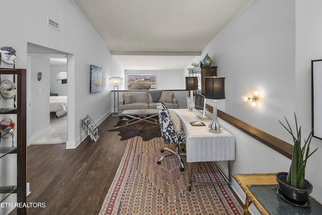 office space with lofted ceiling, wood finished floors, visible vents, and baseboards