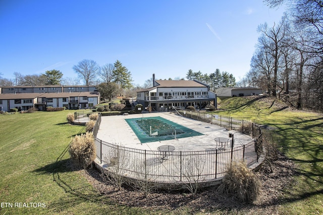 pool featuring a yard, a patio area, and fence