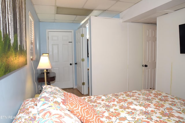 bedroom with a paneled ceiling and a closet