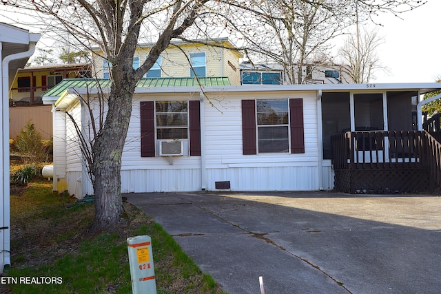 view of front of home featuring cooling unit and a sunroom