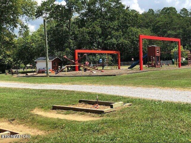 communal playground featuring a lawn