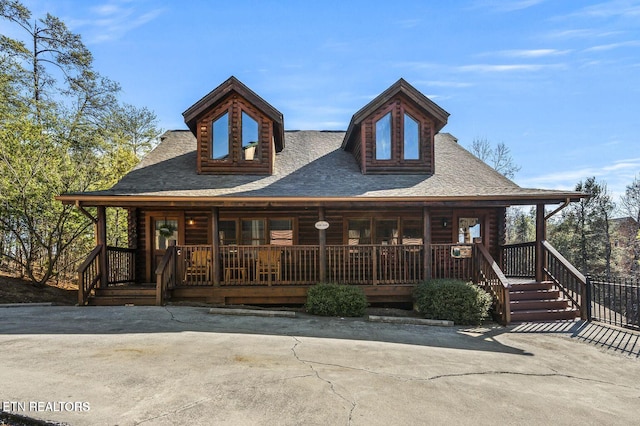 cabin with covered porch and log exterior