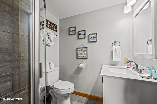 bathroom featuring toilet, baseboards, tiled shower, and vanity