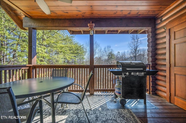 wooden terrace featuring grilling area and outdoor dining area