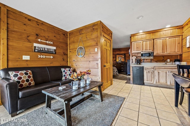 living area featuring recessed lighting, wood walls, and light tile patterned floors