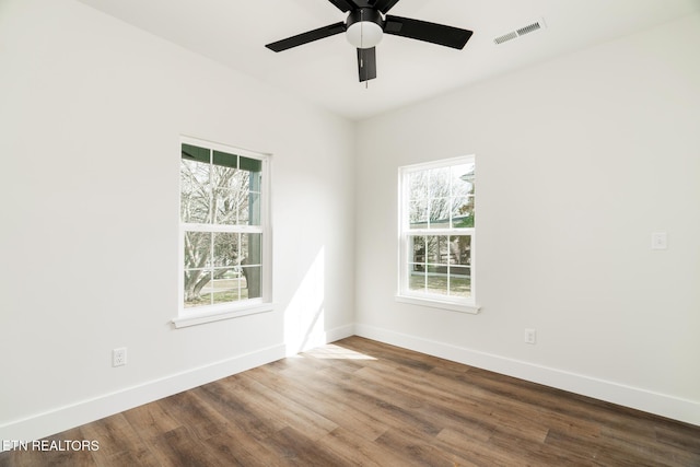 1229 N Main St, Sweetwater, TN 37874 - spare room with visible vents, baseboards, ceiling fan, and dark wood-style flooring