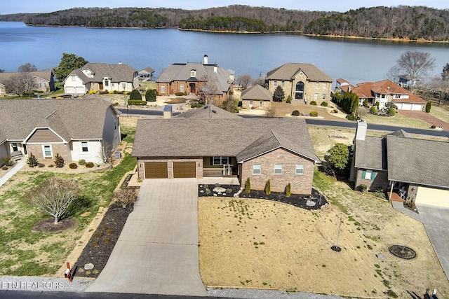 drone / aerial view featuring a residential view and a water view