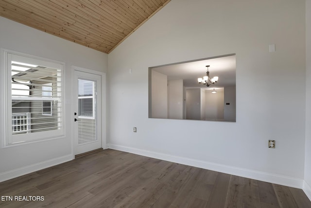 empty room with baseboards, wood ceiling, wood finished floors, a notable chandelier, and high vaulted ceiling