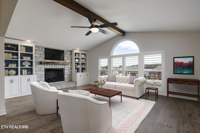 living room featuring a ceiling fan, a fireplace, wood finished floors, baseboards, and lofted ceiling with beams
