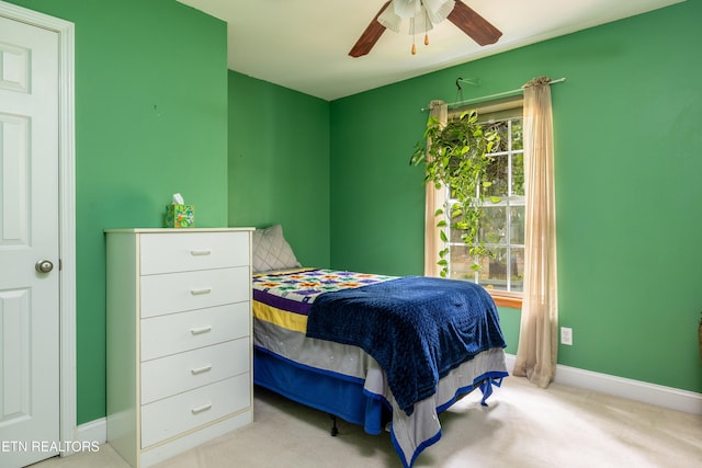 carpeted bedroom with a ceiling fan and baseboards