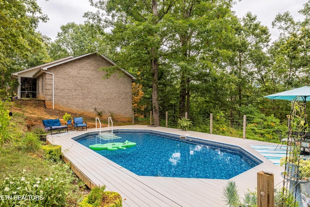 outdoor pool featuring a deck