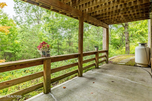 view of patio / terrace with a forest view