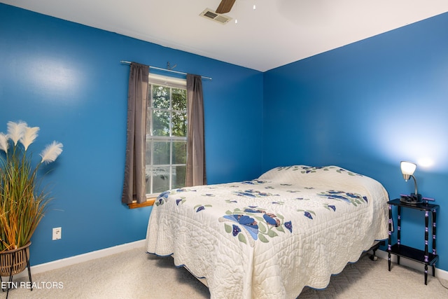 carpeted bedroom with visible vents, ceiling fan, and baseboards