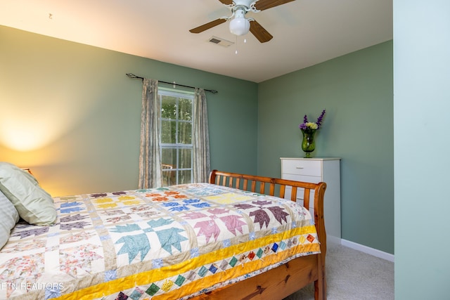 carpeted bedroom featuring baseboards, visible vents, and a ceiling fan