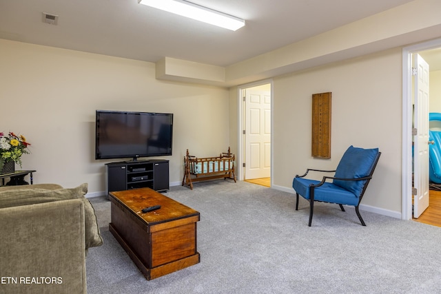 living room featuring baseboards, visible vents, and carpet flooring