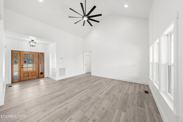 unfurnished living room featuring high vaulted ceiling, baseboards, visible vents, and light wood-style floors