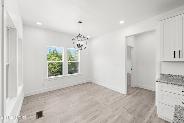 unfurnished dining area with recessed lighting, baseboards, visible vents, and light wood finished floors