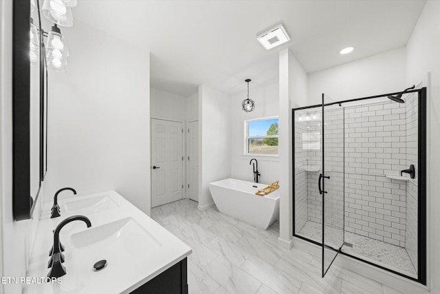 bathroom with a stall shower, a soaking tub, a sink, and double vanity