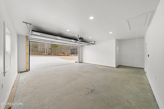 garage featuring baseboards, recessed lighting, and a garage door opener