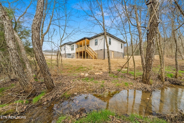 exterior space with crawl space and stairway