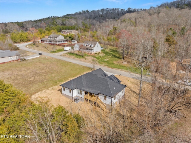 drone / aerial view featuring a view of trees