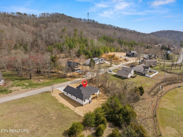 birds eye view of property featuring a wooded view