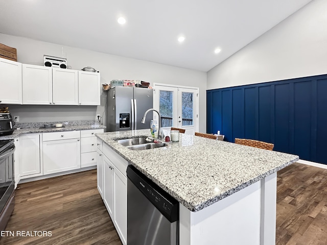 kitchen featuring french doors, dark wood finished floors, appliances with stainless steel finishes, white cabinetry, and a sink