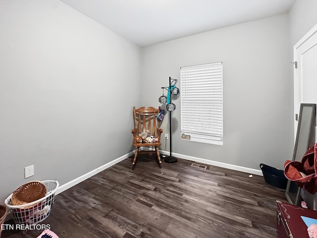 misc room with dark wood-type flooring, visible vents, and baseboards