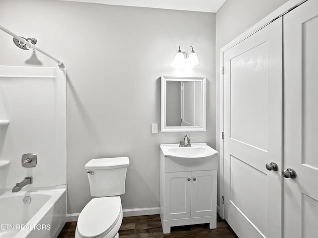 bathroom featuring baseboards, toilet, shower / tub combination, wood finished floors, and vanity