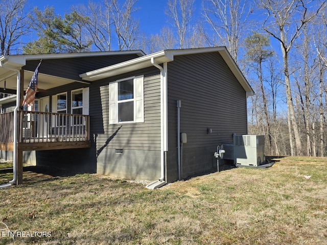 view of property exterior with crawl space, a lawn, and central air condition unit