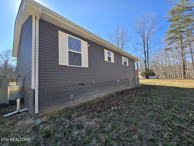 view of home's exterior with crawl space and a yard