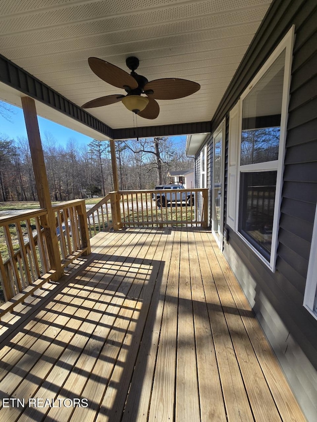 wooden deck featuring a ceiling fan