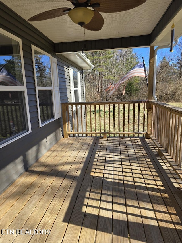 wooden terrace featuring a ceiling fan