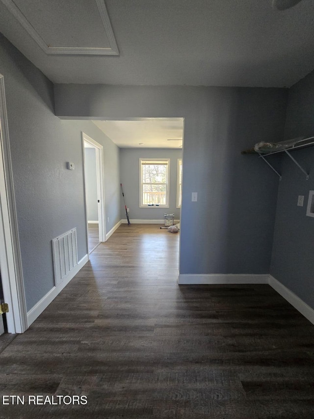 interior space with wood finished floors, visible vents, and baseboards