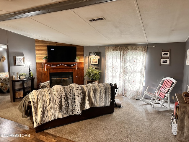 137 Summerset Ln, Pioneer, TN 37847 - living room with lofted ceiling with beams, wood finished floors, a glass covered fireplace, and visible vents