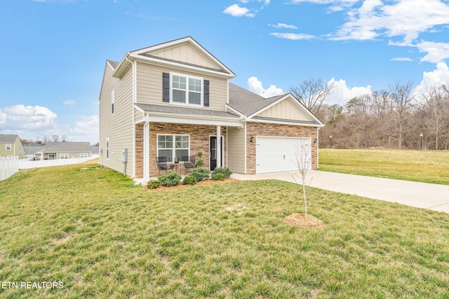 view of front of house with board and batten siding, fence, a garage, driveway, and a front lawn