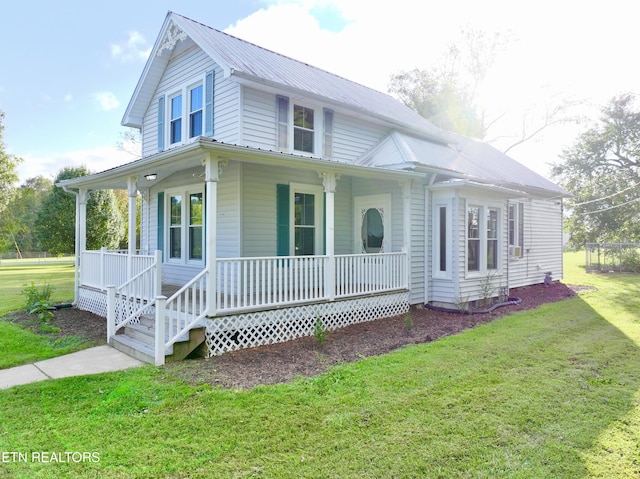 country-style home with metal roof, a porch, and a front yard