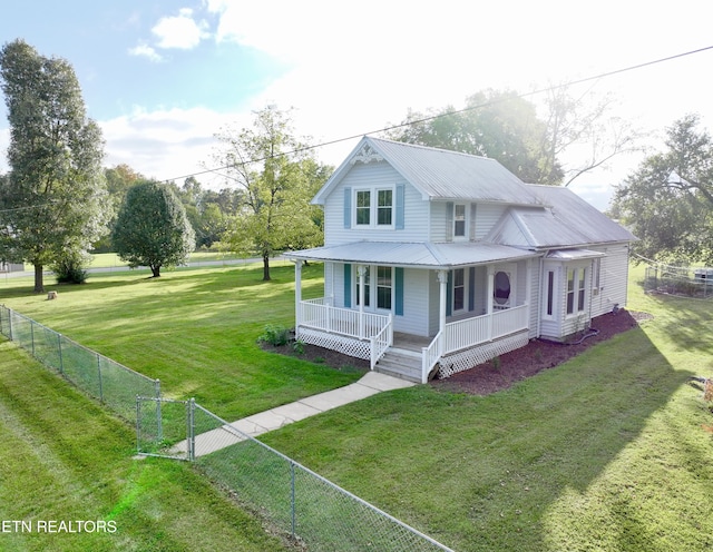 farmhouse inspired home with metal roof, a porch, fence private yard, a gate, and a front yard