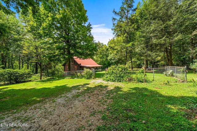 view of yard featuring fence and a view of trees