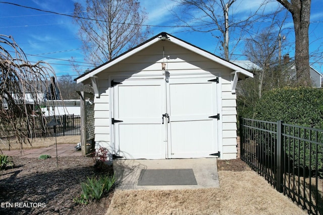 view of shed featuring fence