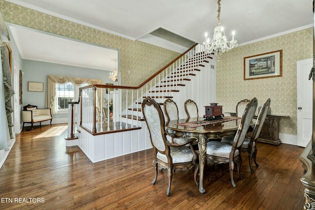 dining area featuring hardwood / wood-style flooring, an inviting chandelier, and wallpapered walls