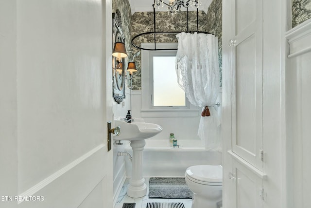 bathroom featuring toilet and tile patterned flooring