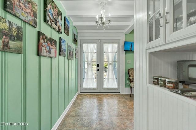 doorway to outside featuring a chandelier, beam ceiling, and french doors