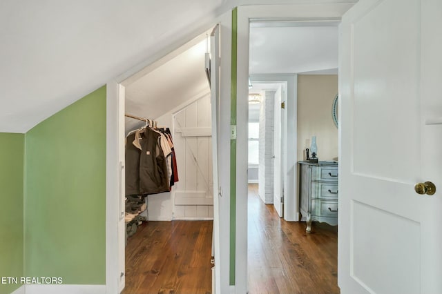 interior space featuring lofted ceiling and dark wood-type flooring