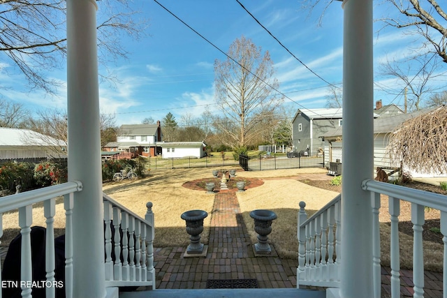 view of yard featuring a porch and fence