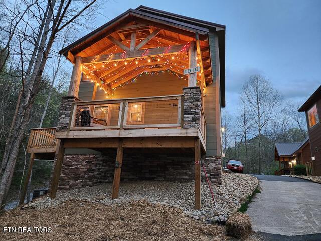 exterior space with driveway, a deck, and an attached garage