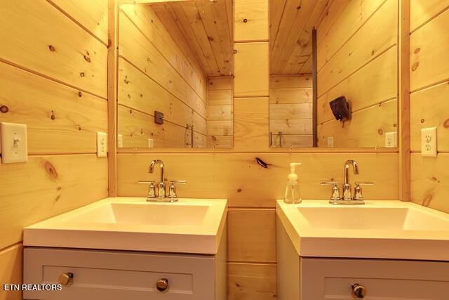 bathroom featuring wood ceiling, vanity, and wooden walls