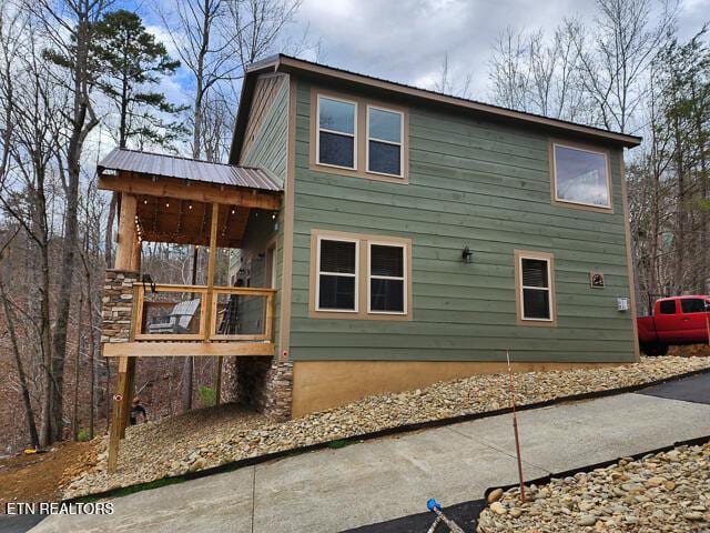 rear view of house with metal roof