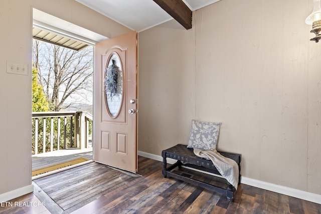 foyer featuring beamed ceiling, baseboards, and wood finished floors