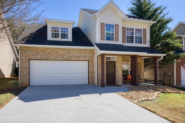 traditional home featuring a porch, an attached garage, brick siding, concrete driveway, and roof with shingles